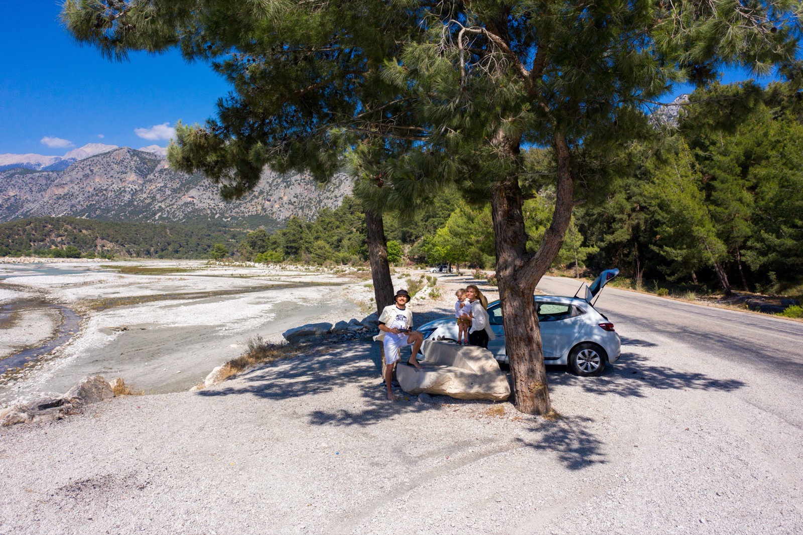 A family taking a roadside break beside the coast